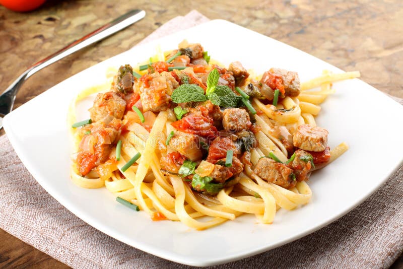 Pasta with chunks of fresh tuna, tomato and mint royalty free stock photos