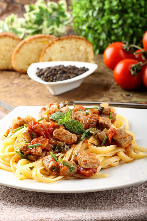 Pasta with chunks of fresh tuna, tomato and mint royalty free stock images