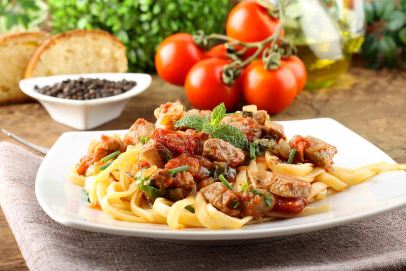 Pasta with chunks of fresh tuna, tomato and mint stock photography