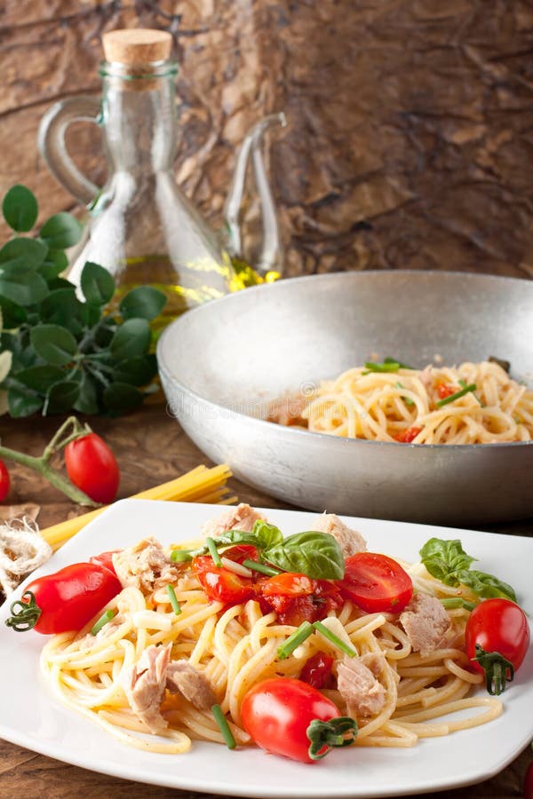 Pasta with fresh tomatoes, tuna and basil stock photo