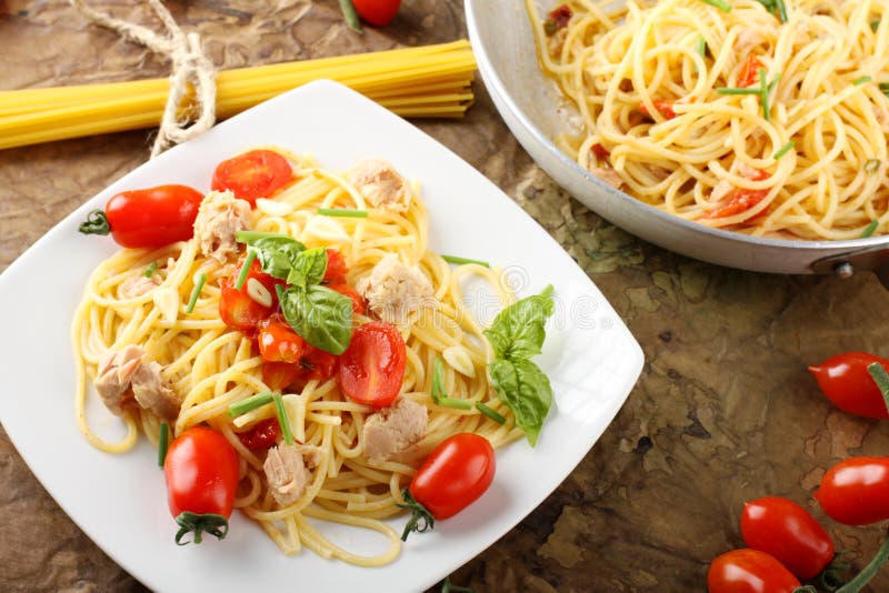 Pasta with fresh tomatoes, tuna and basil stock image