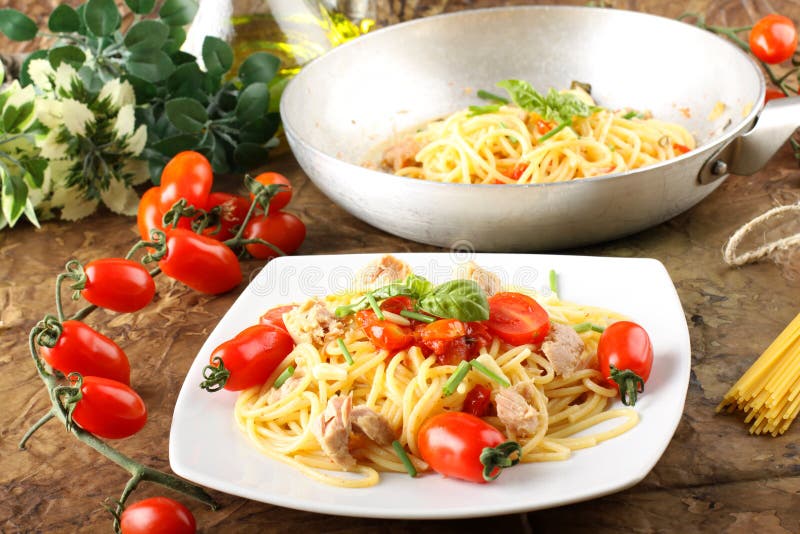 Pasta with fresh tomatoes, tuna and basil stock photography