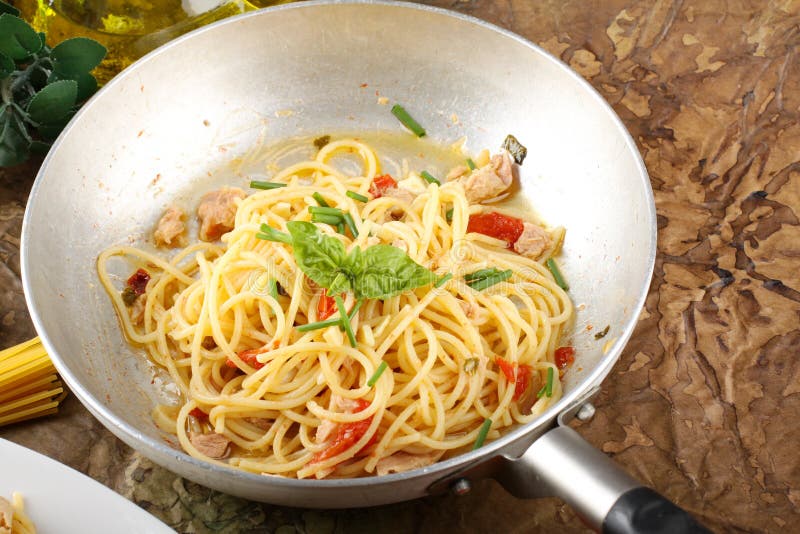 Pasta with fresh tomatoes, tuna and basil stock photo