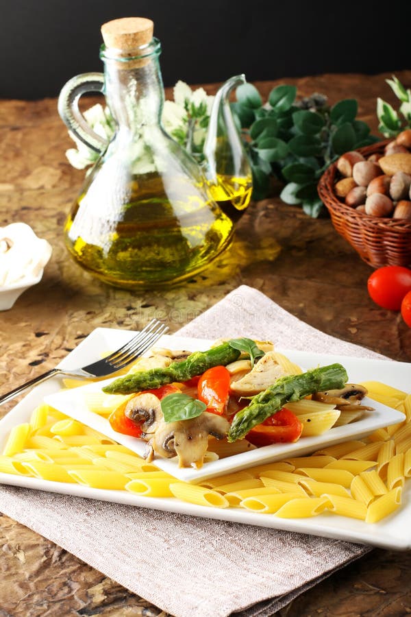 Pasta with fresh tuna, mushrooms and asparagus royalty free stock image