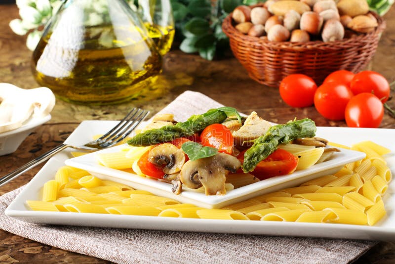 Pasta with fresh tuna, mushrooms and asparagus royalty free stock image