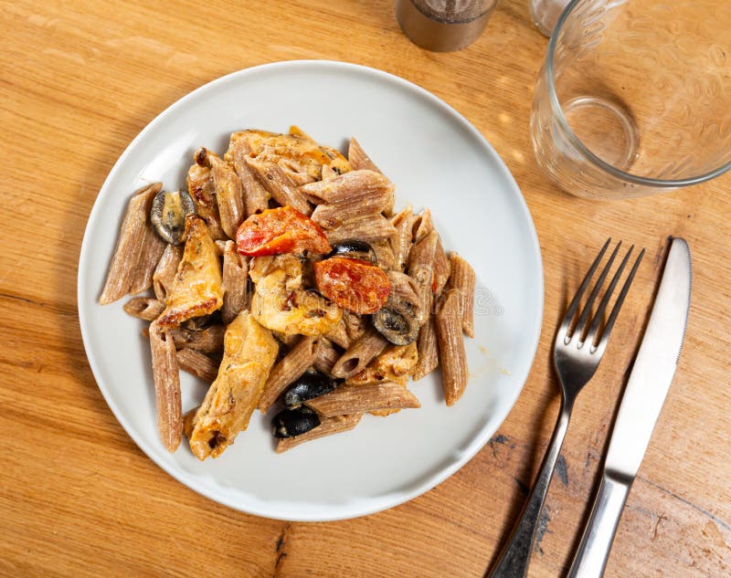 Pasta with fried chicken and vegetables royalty free stock image