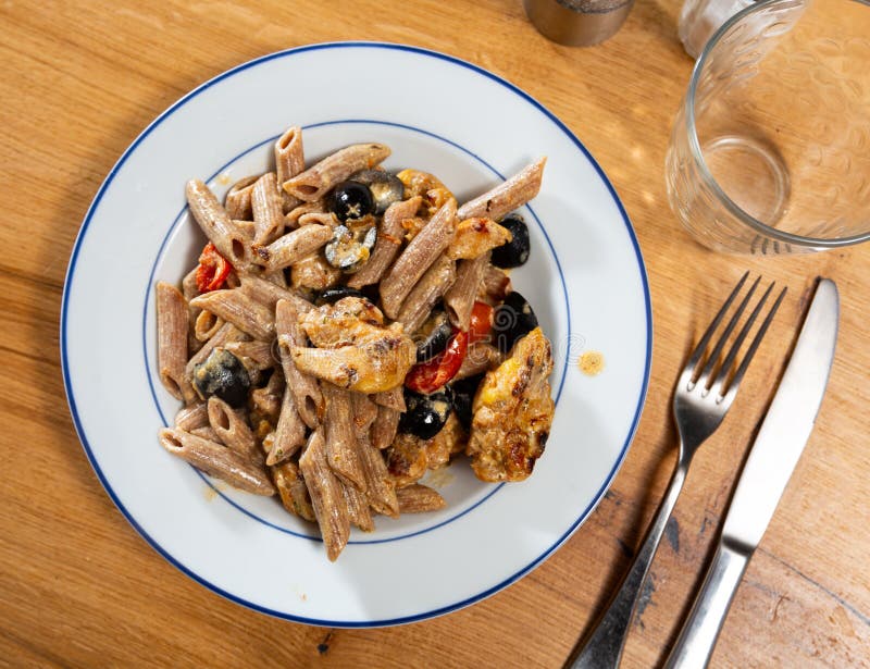 Pasta with fried chicken and vegetables stock photo