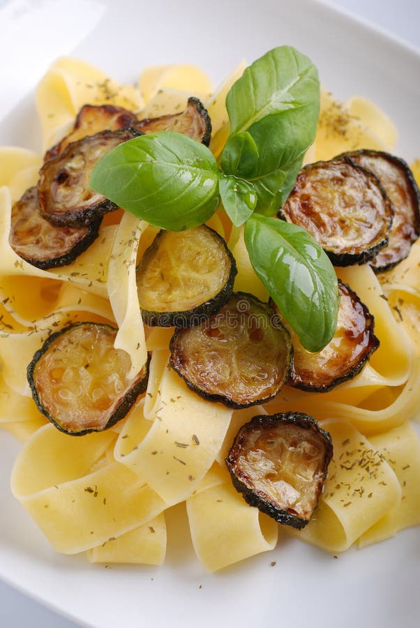 Pasta with fried zucchini stock image. Image of plate 30997533
