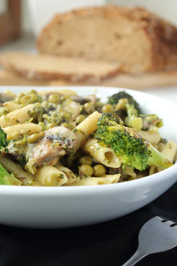 Pasta with Green Vegetables and Creamy Sauce in White Bowl. Stock Photo