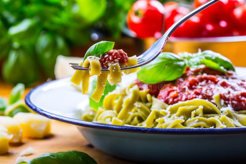 Pasta. Italian and Mediterranean cuisine. Pasta Fettuccine with tomato sauce basil leaves garlic and parmesan cheese. An old home