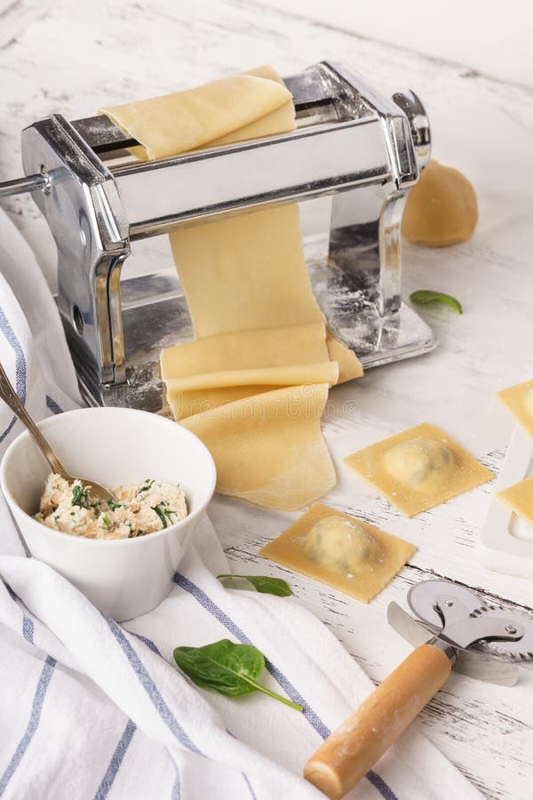Pasta Machine and Fresh Homemade Uncooked Ravioli with Filling Stock