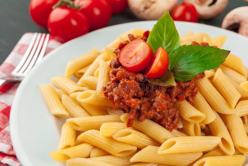 Pasta with Meat, Tomato Sauce and Vegetables on the Table Stock Image