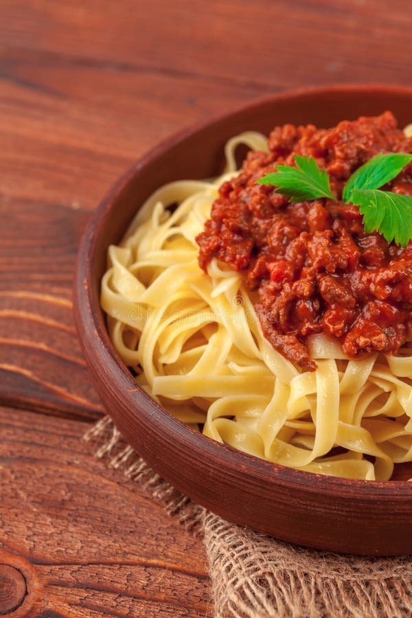 Pasta with Meat, Tomato Sauce and Vegetables on the Table Stock Photo