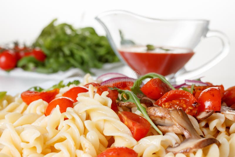 Pasta with mushrooms, cherry tomatoes and tomato sauce, italian food. Closeup