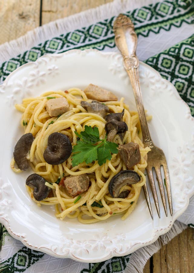 Pasta with Mushrooms and Meat in a Creamy Sauce. Spaghetti, Oyster