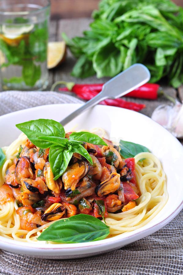 Pasta with mussels, pepperoni, bacon, tomato and basil