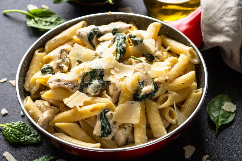 Pasta Penne with Chicken and Spinach in Creamy Sauce. Stock Photo