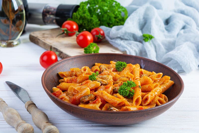 Pasta Penne in Marinara Sauce with Mussels, Onion and Parsley. Classic ...