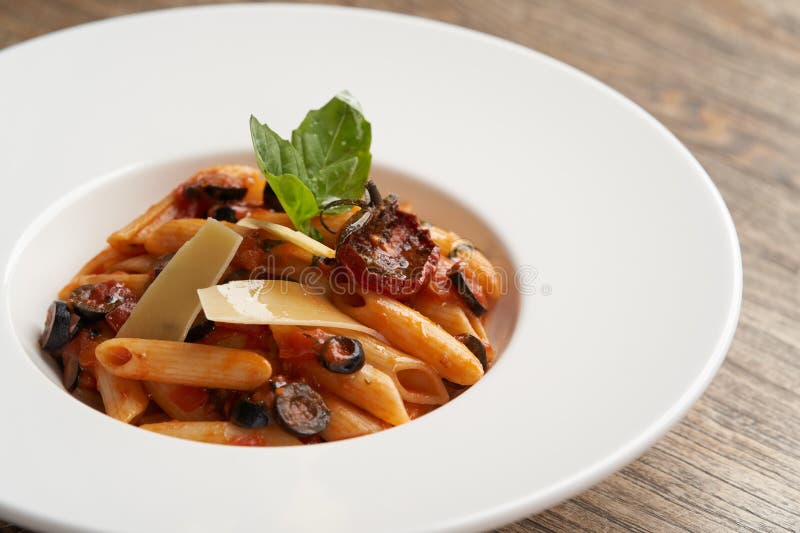 Pasta Penne with Tomato, Olives and Basil Stock Image - Image of