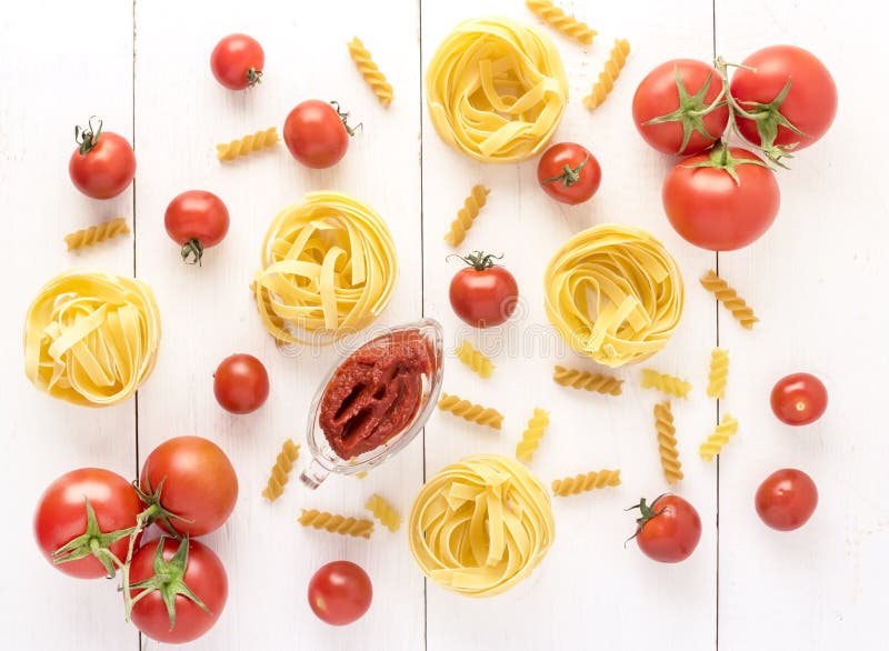 Pasta Products with Tomato Raw Pasta Fusili Fettuccine Ingredients Italian Food White Background Top View Flat lay