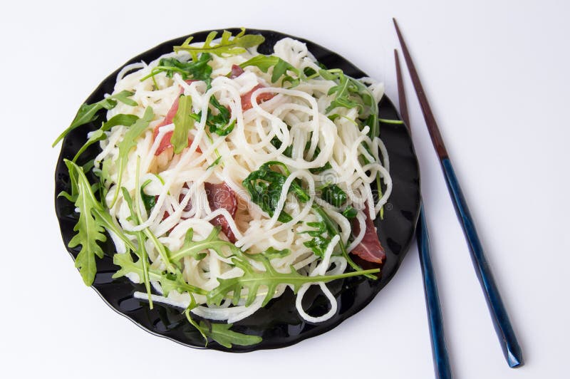 Pasta with Prosciutto and Arugula Vegetable on a Plate Stock Image