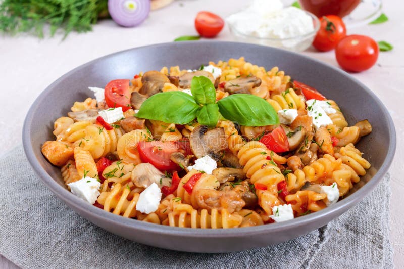 Pasta Radiatori with chicken, mushrooms, cherry tomatoes, feta cheese and tomato sauce