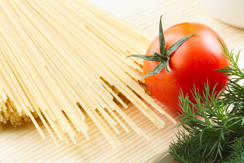 Dry Pasta on a Cutting Board on a Background of Blue Boards Stock Photo