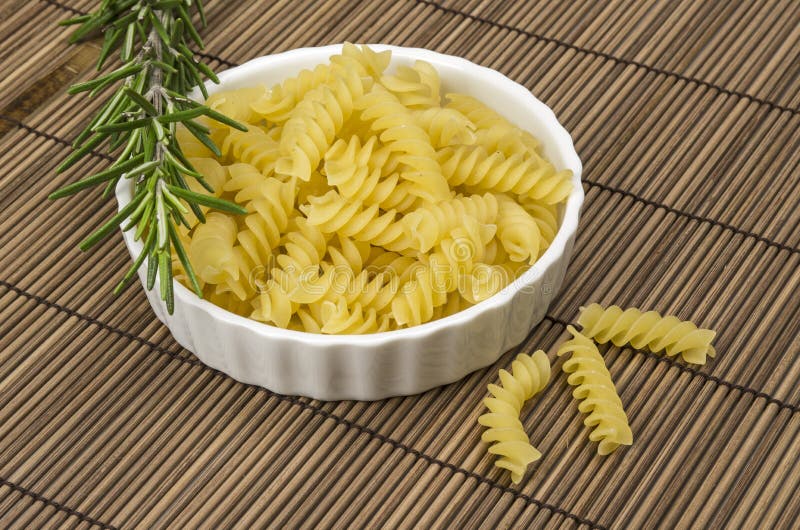 Pasta and rosemary stock photo. Image of fusili, herb 30748876