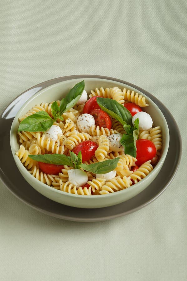 Pasta Salad with Cherry Tomatoes and Basil Leaves Stock Image - Image