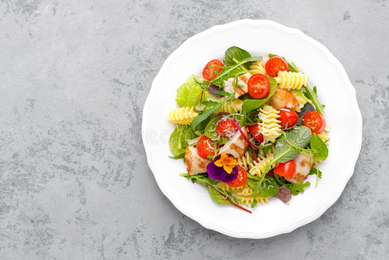Pasta salad with grilled chicken meat, vegetables and cheese stock image Pasta salad with grilled chicken meat, vegetables and cheese stock image