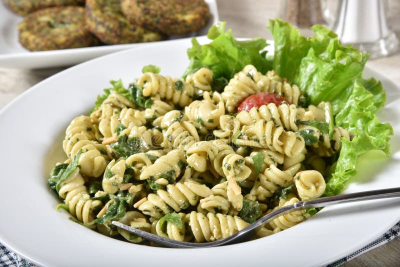 Pasta salad and spinach cakes stock photo