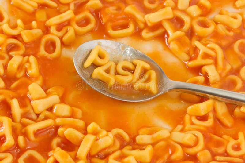 Pasta Shaped Letters Spelling The Word PASTA In Tomato Sauce On Stock