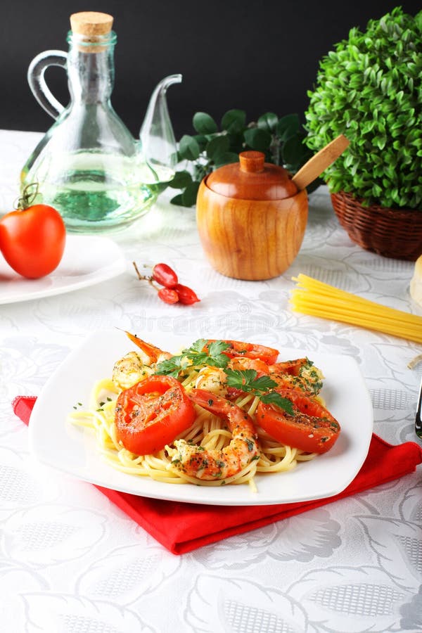 Pasta with shrimp, fresh tomatoes and parsley stock photos