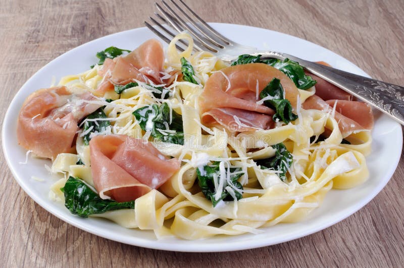 Pasta with spinach and ham stock photo. Image of hour 61120130