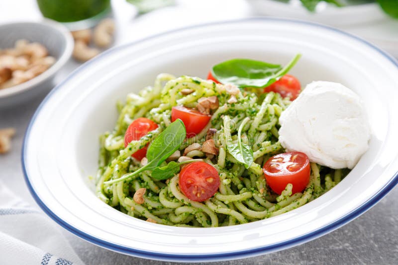 Pasta with Spinach Pesto, Cashew Nuts and Soft Cream Cheese Stock Photo