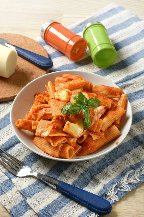 Pasta with Tomato Sauce with Pieces of Melted Cheese Stock Photo