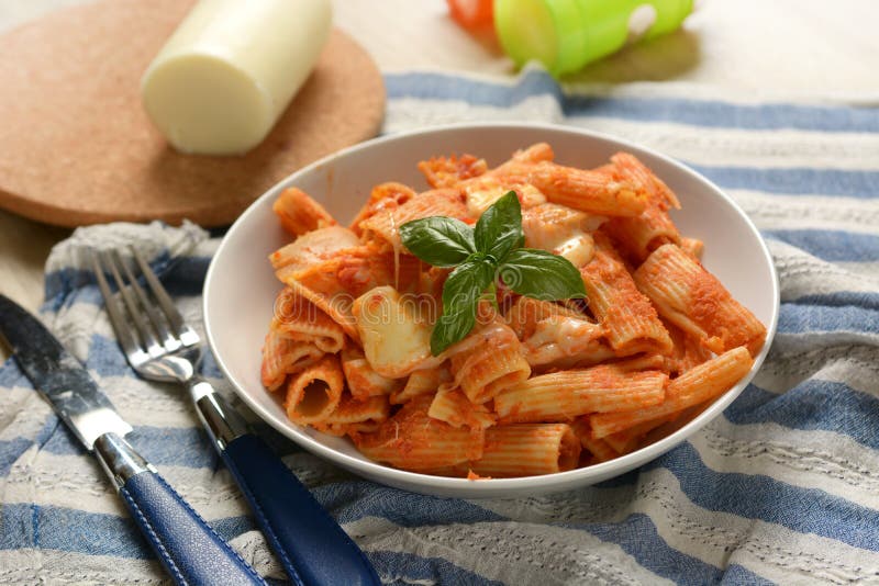 Pasta with Tomato Sauce with Pieces of Melted Cheese Stock Photo