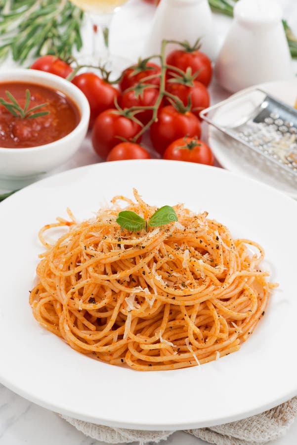 Pasta with Tomato Sauce on a Plate and Ingredients, Vertical Stock