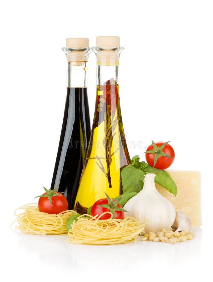 Olive Oil and Vinegar Bottles with Basil and Tomatoes Stock Image