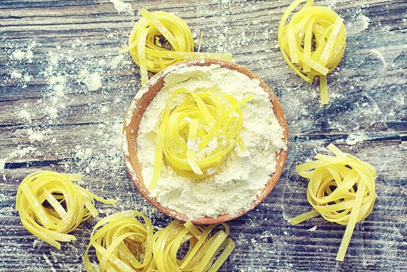 Pasta uncooked on the table. Noodles in the form of nests stock photos