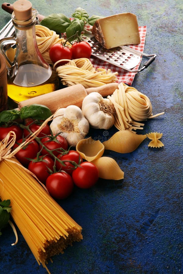 Pasta, Vegetables, Herbs and Spices for Italian Food on Rustic Table