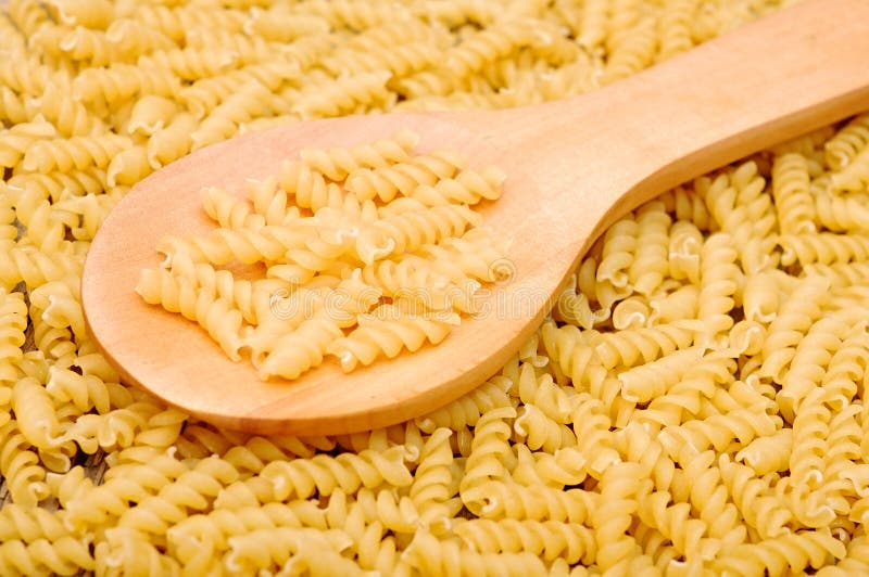 Pasta and a wooden spoon stock photo. Image of spoon 27993766