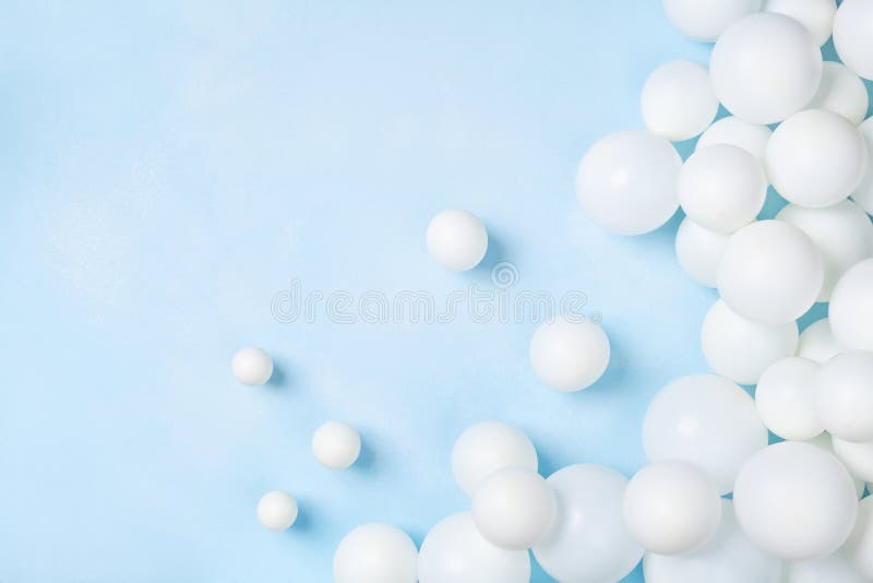 Pastel blue table with white balloons top view. Party or birthday background. Flat lay style stock photo Pastel blue table with white balloons top view. Party or birthday background. Flat lay style stock photo