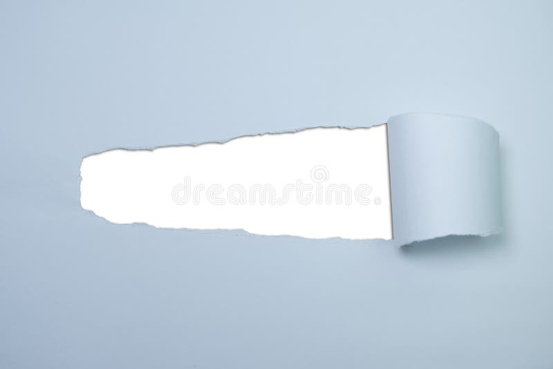 Pastel blue torn paper with hole revealing white copy space in centre royalty free stock photo