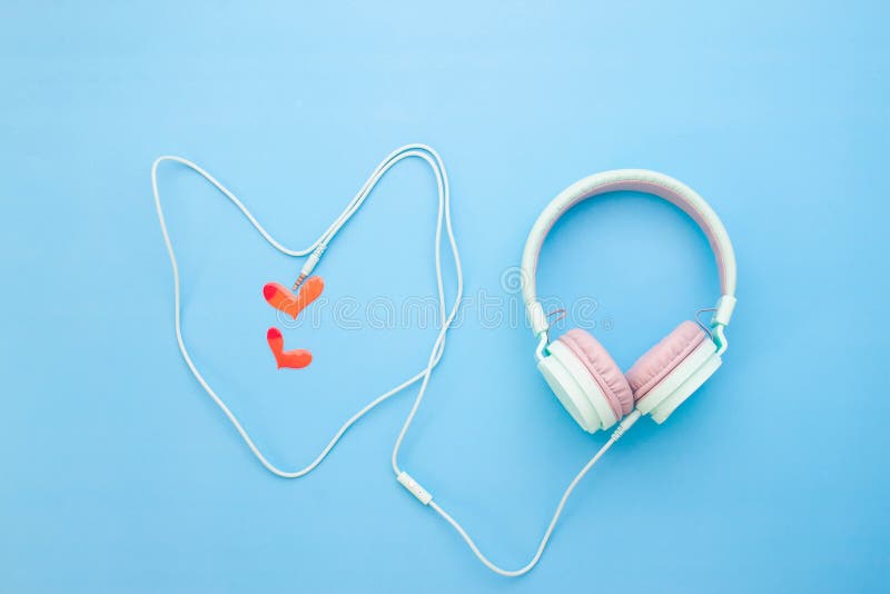 Pastel color headphone heart shape with little red heart on blue