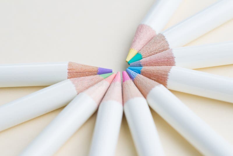 Pastel color pencils arrange in circle with copy space on light