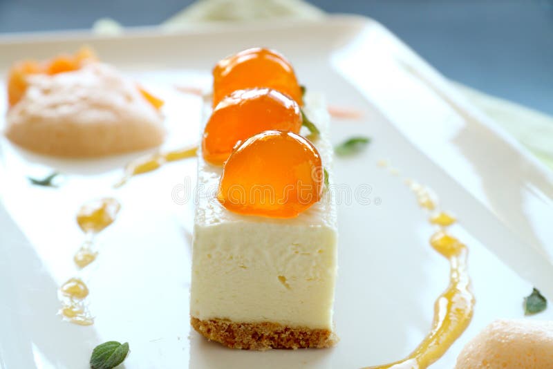 Delicious mandarin cheese cake with mandarin balls and a fruit sauce. Delicious mandarin cheese cake with mandarin balls and a fruit sauce.