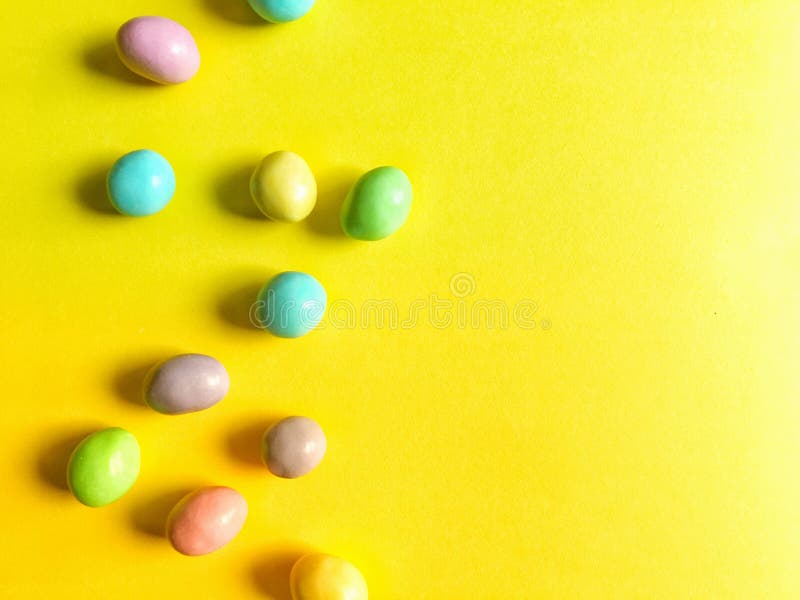 Bright Pastel Easter Candy on Blue and Purple Ombre Background Stock