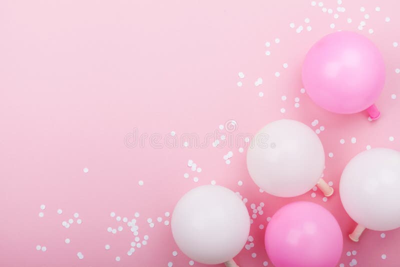 Pastel pink table with balloons and confetti for birthday from above. Flat lay composition. stock images Pastel pink table with balloons and confetti for birthday from above. Flat lay composition. stock images