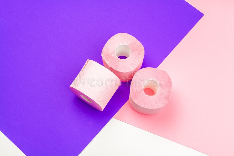 Pastel pink toilet paper rolls on black wooden background Stock Photo by  FabrikaPhoto
